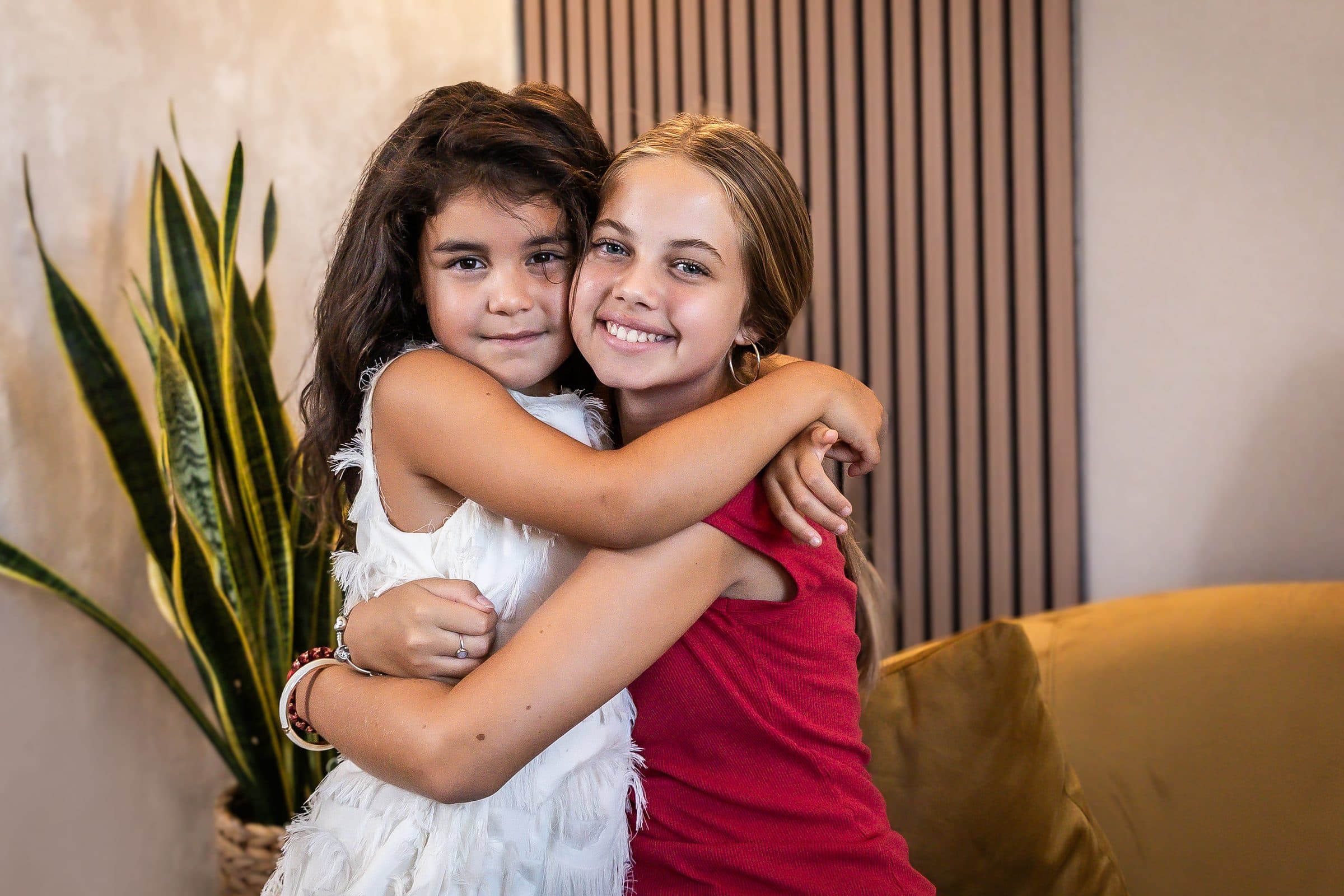 Dos niñas abrazadas en el estudio tras su Family Podcast